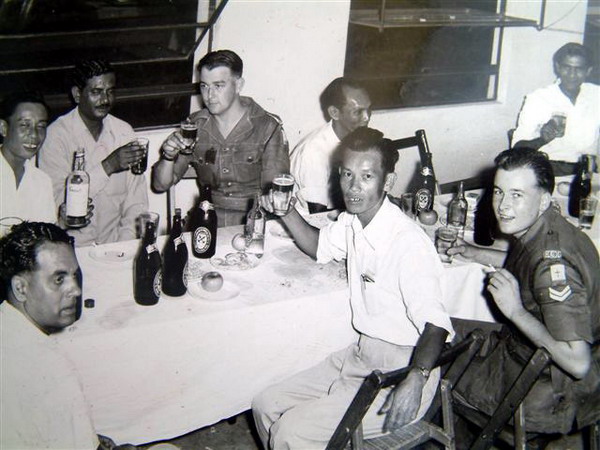 PM001p4.JPG - Maj. Ted Macey Christmas Party in the orderly room at Alexandra Barracks, Singapore - 1956  The other end of the table. Also showing Cpl. Keith Bone, who sent these photos.  Any details, memories or photographs that you may have would be most welcome.